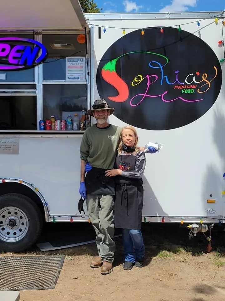 Sophia and Glen standing together outside their food truck