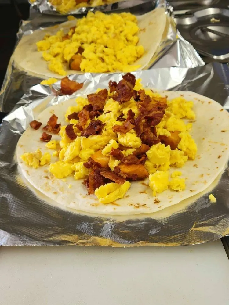 Breakfast burritos with scrambled eggs and bacon, rolled fresh
