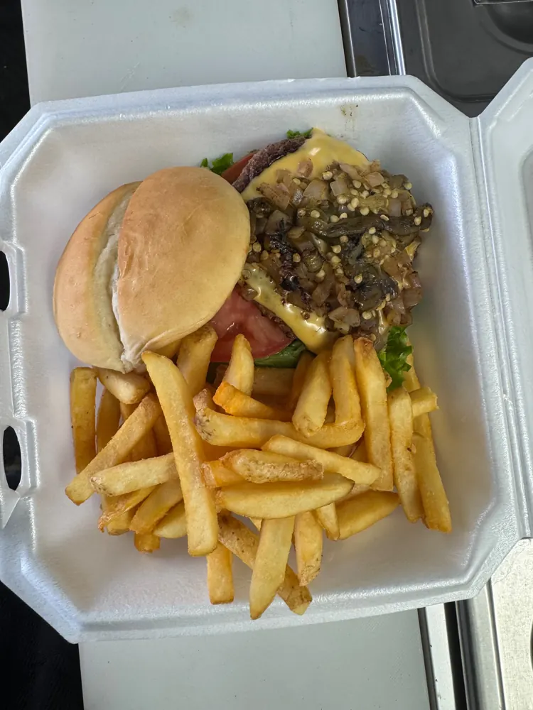 Andrew's Spicy Cheeseburger topped with roasted green chili and grilled onions, with fries