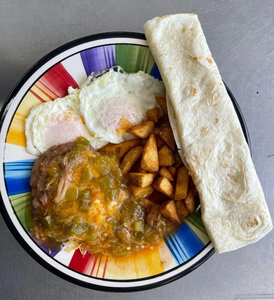 Huevos rancheros with two eggs, potatoes, beans, green chili and a flour tortilla