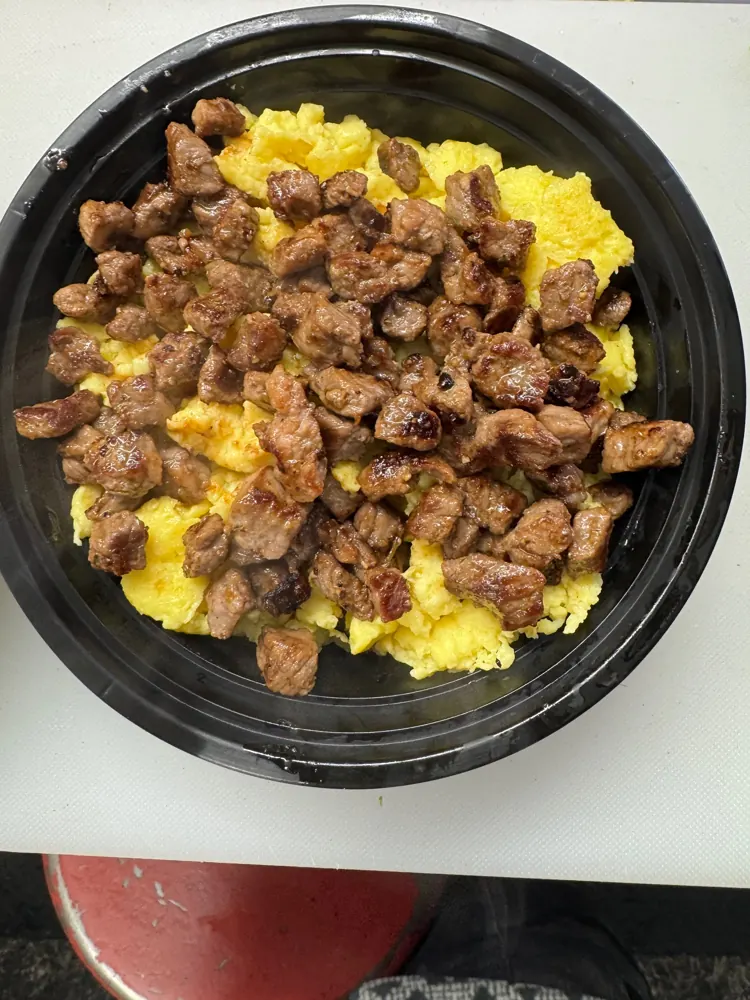 Breakfast keto bowl with scrambled eggs and grilled steak