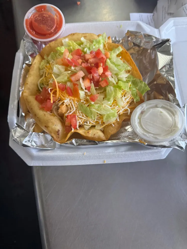 Kayla's Taco Salad in a fried flour tortilla bowl with lettuce, cheese and tomato